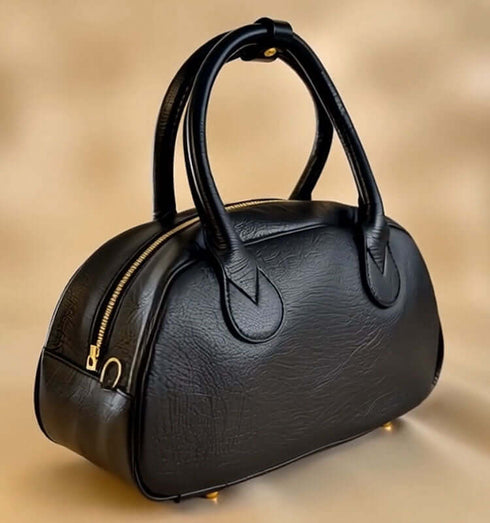 תיק שחור קטן מעור עם ידיות נוחות ועיצוב מודרני, מושלם לשימוש יומיומי והוספת סטייל.