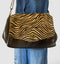 Italian leather and fur handbag in leopard and black, featuring a stylish clasp and shoulder strap.