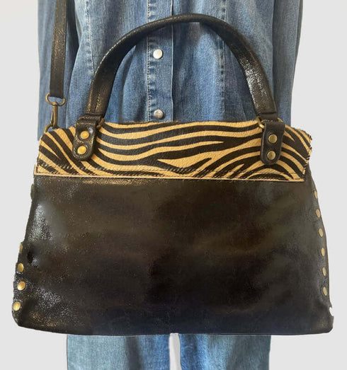 Stylish Italian leather handbag in black with leopard print and copper accents, perfect for any outfit.