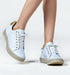 Stylish white espadrille sneakers with lace-up design and contrasting sole, ideal for casual wear.