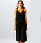 A model wearing a sleek black satin dress, showcasing a flattering fit and elegant design, perfect for special occasions.