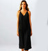 A model wearing a sleek black satin dress, showcasing a flattering fit and elegant design, perfect for special occasions.
