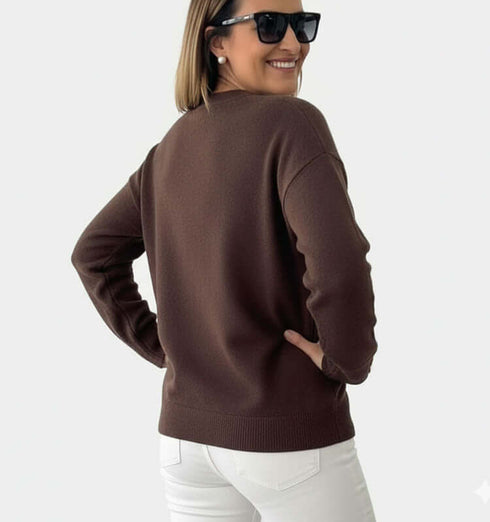 אישה עם סריג דק במרקם קטיפתי בגוון חום, מתאימה לאלגנטיות יומיומית.